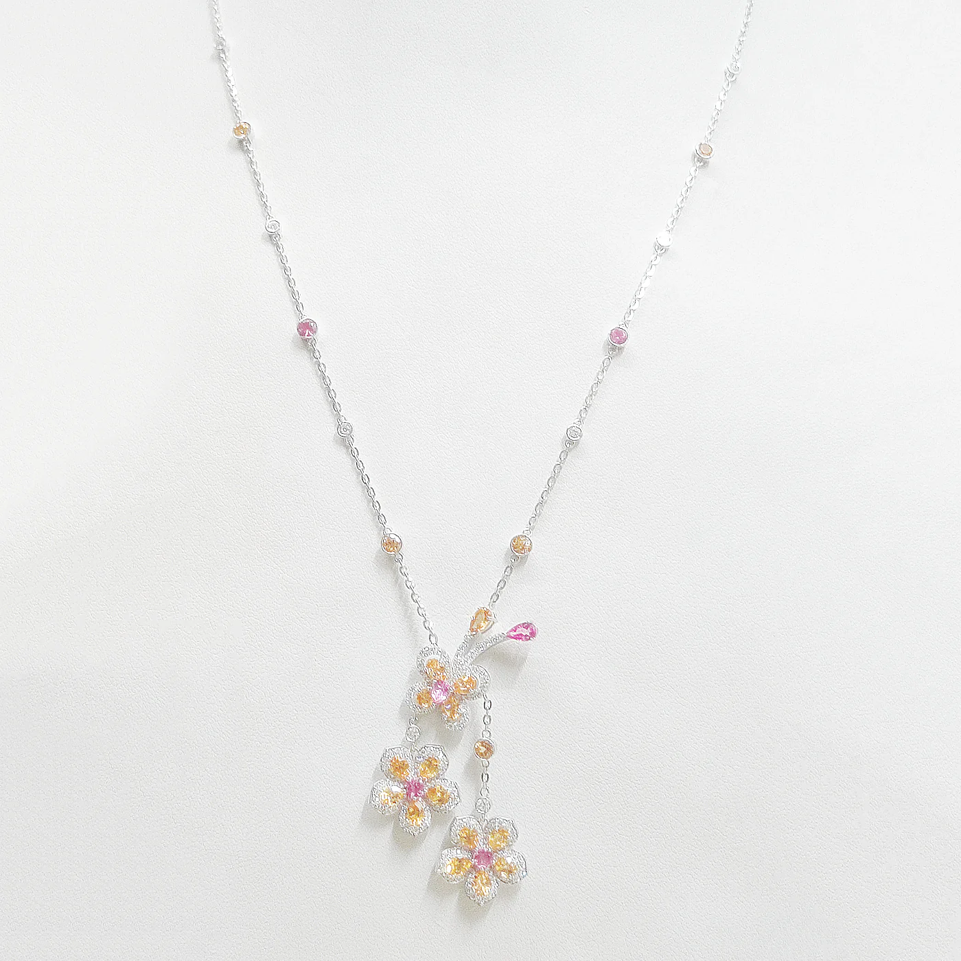 Pink spinel and spessartite bloom long chain
