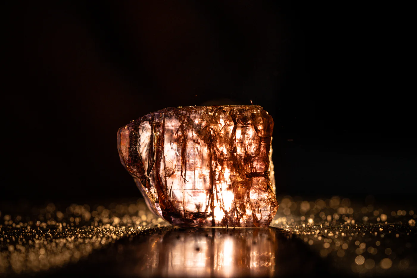 A rough gemstone lit from within, before it is cut.