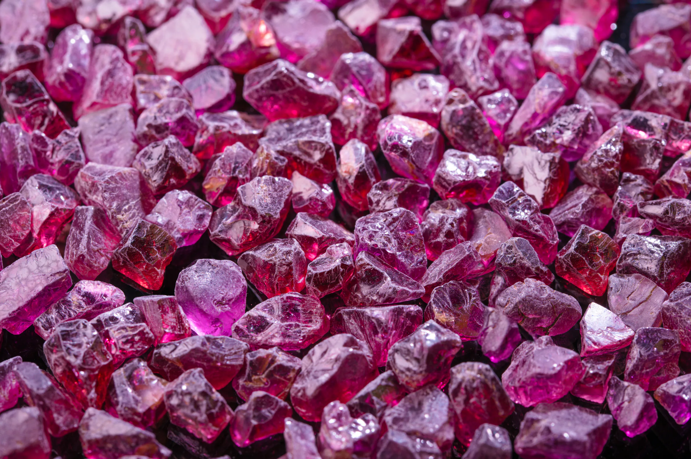 Rough rhodolite garnet crystals in raspberry and rose.