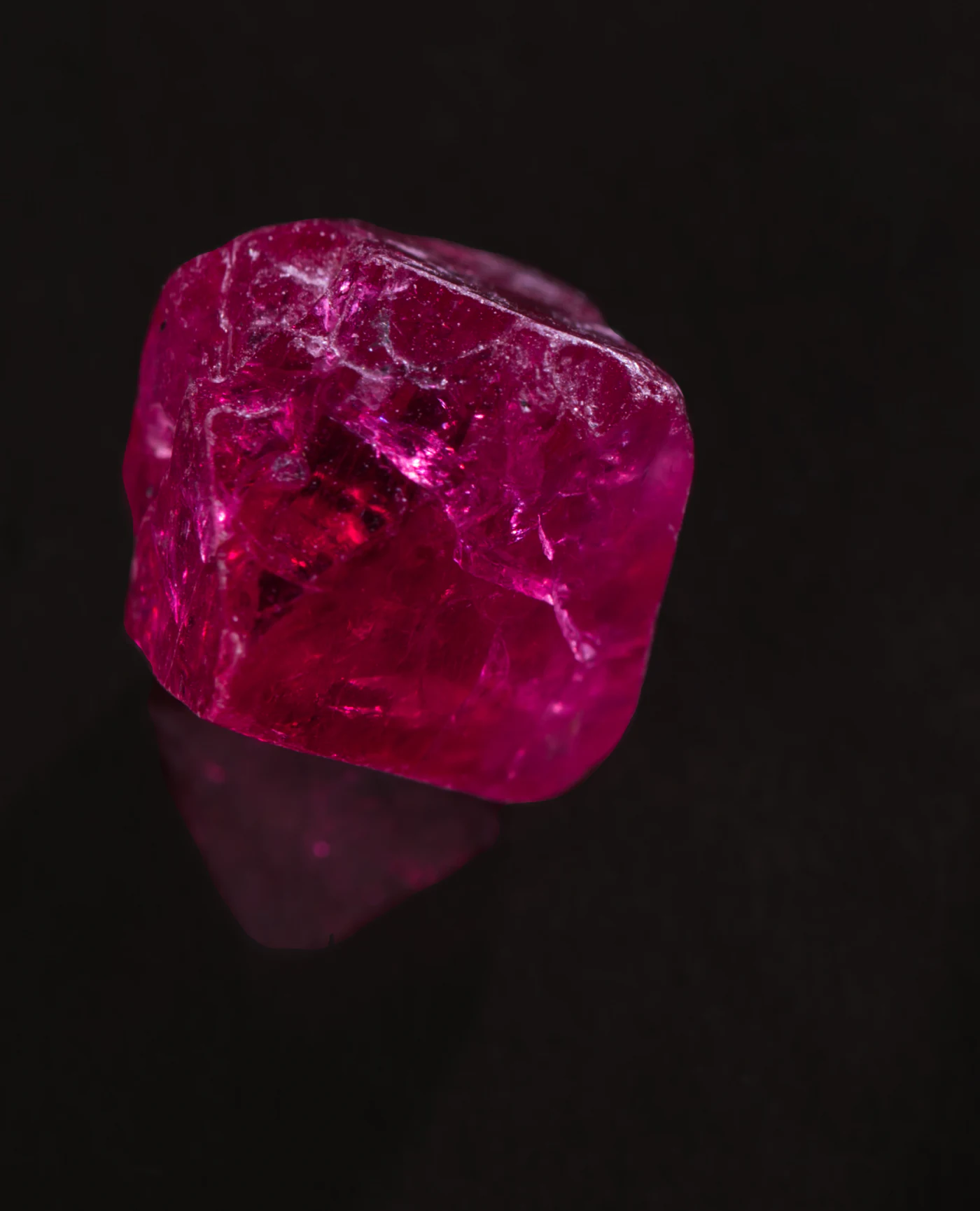 Rough pink spinel on black.