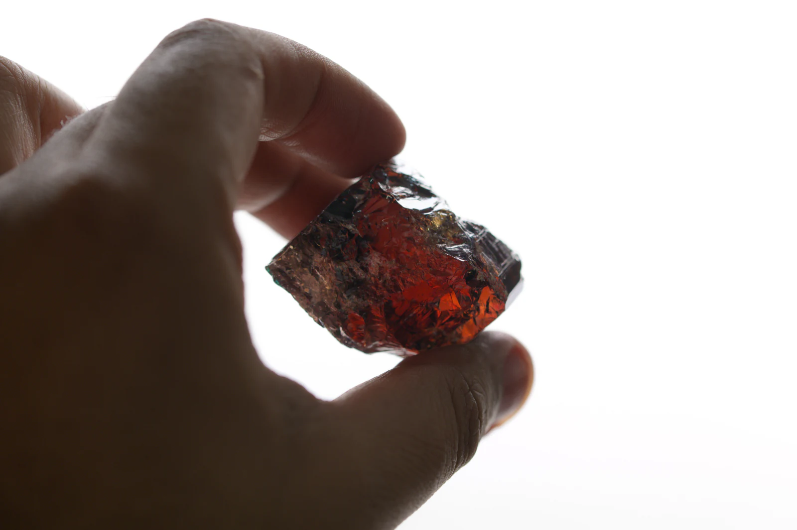 A rough stone held to the light, glowing deep red.